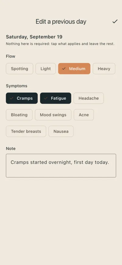 The log screen for one day: flow chips with Medium selected, symptom chips with Cramps and Fatigue selected, and a short note. A line at the top says nothing here is required.